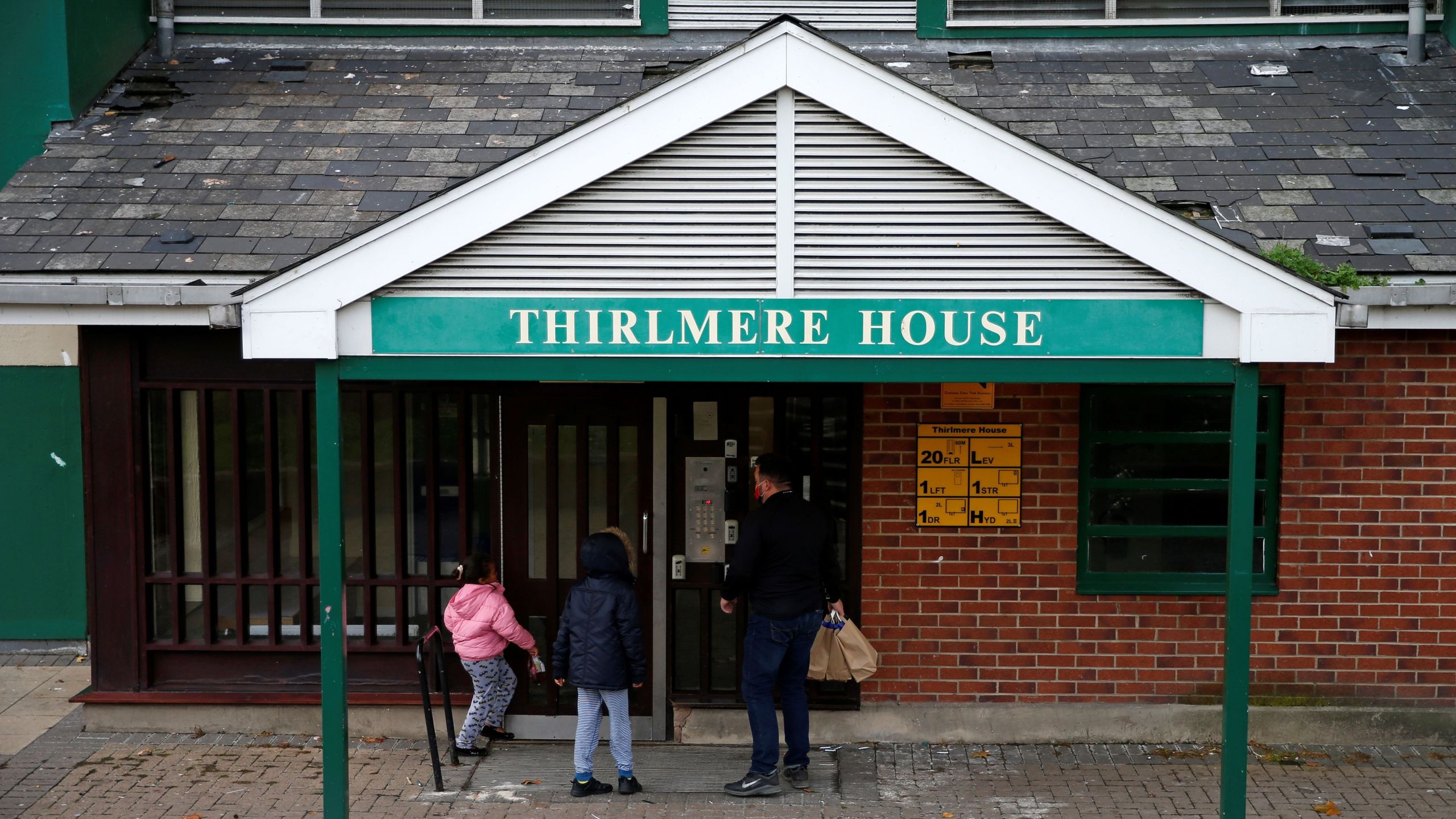 Dom Palacio, Head of Community at Richmond Rugby, delivers meals to local school children living in a block of flats on the Ivybridge estate in Twickenham, south west London, on Oct. 26, 2020, following the British Government's announcement not extend free school meals for children during the school holidays and periods of lockdown. (HOLLIE ADAMS/AFP via Getty Images)