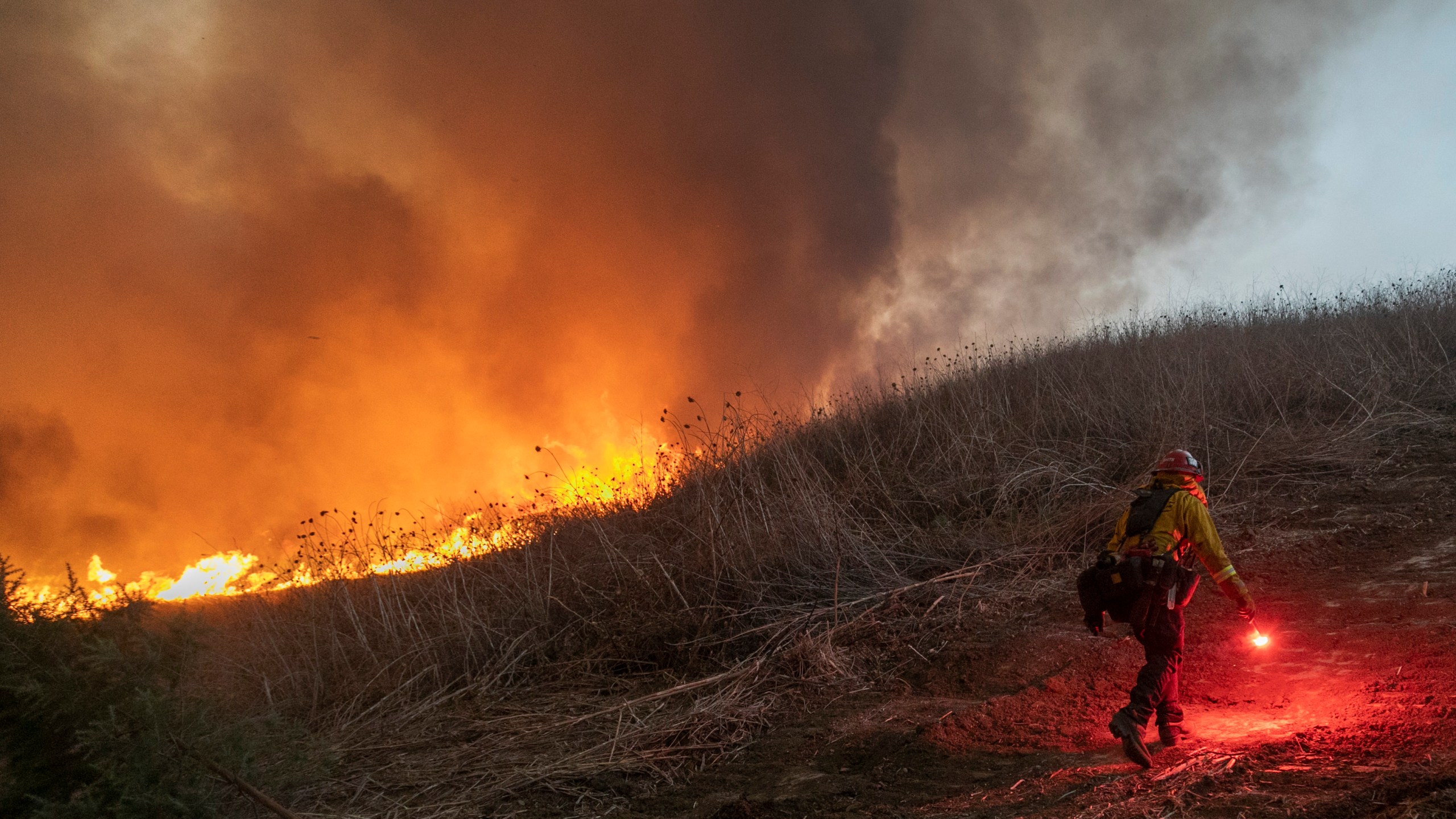 Firefighters set a backfire to protect homes as they try to contain the Blue Ridge Fire in Chino Hills on Oct. 27, 2020. (David McNew / Getty Images)