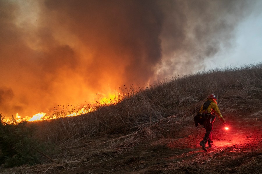 Firefighters set a backfire to protect homes as they try to contain the Blue Ridge Fire in Chino Hills on Oct. 27, 2020. (David McNew / Getty Images)