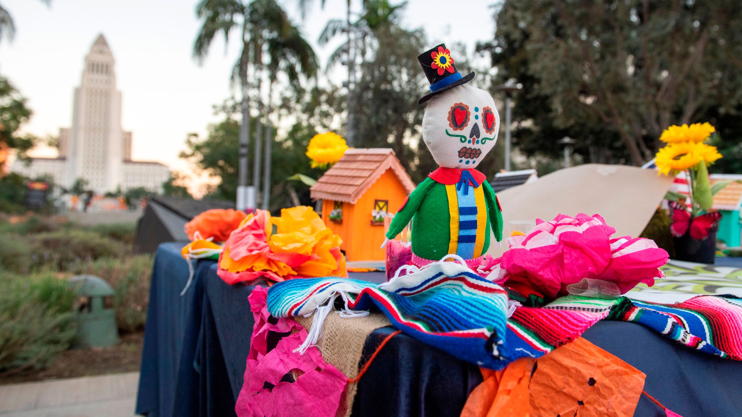 Los Angeles City Hall is seen behind an altar during a socially distant public art installation put together by The Music Center for Grand Park's 8th annual Downtown Dia de los Muertos, October 29, 2020, in Los Angeles, California. (Photo by Valerie Macon/AFP via Getty Images)