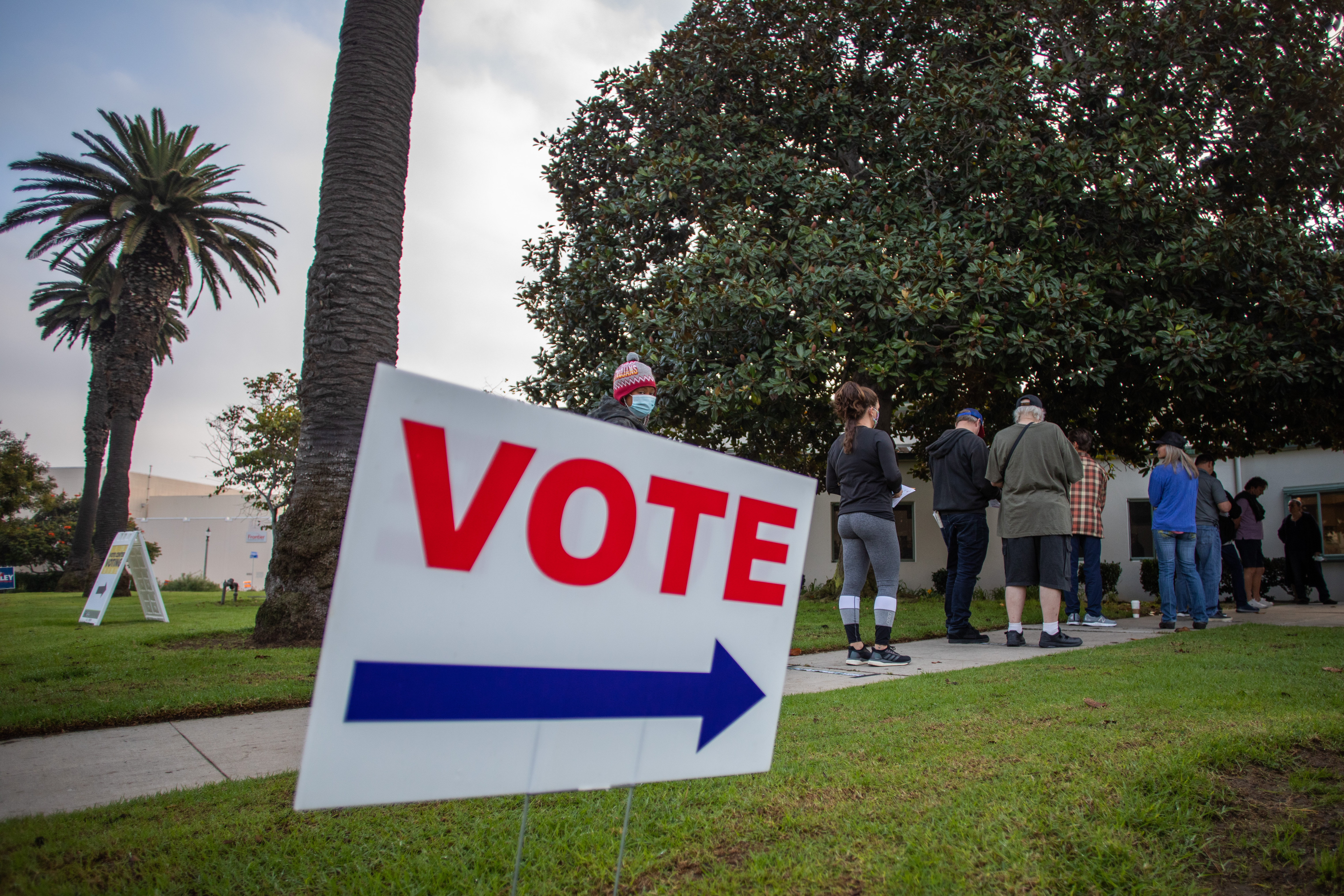 People stand in line to vote as the sun rises the Main Street Branch Library vote center on Nov. 3, 2020, in Huntington Beach, California. (Apu Gomes/Getty Images)