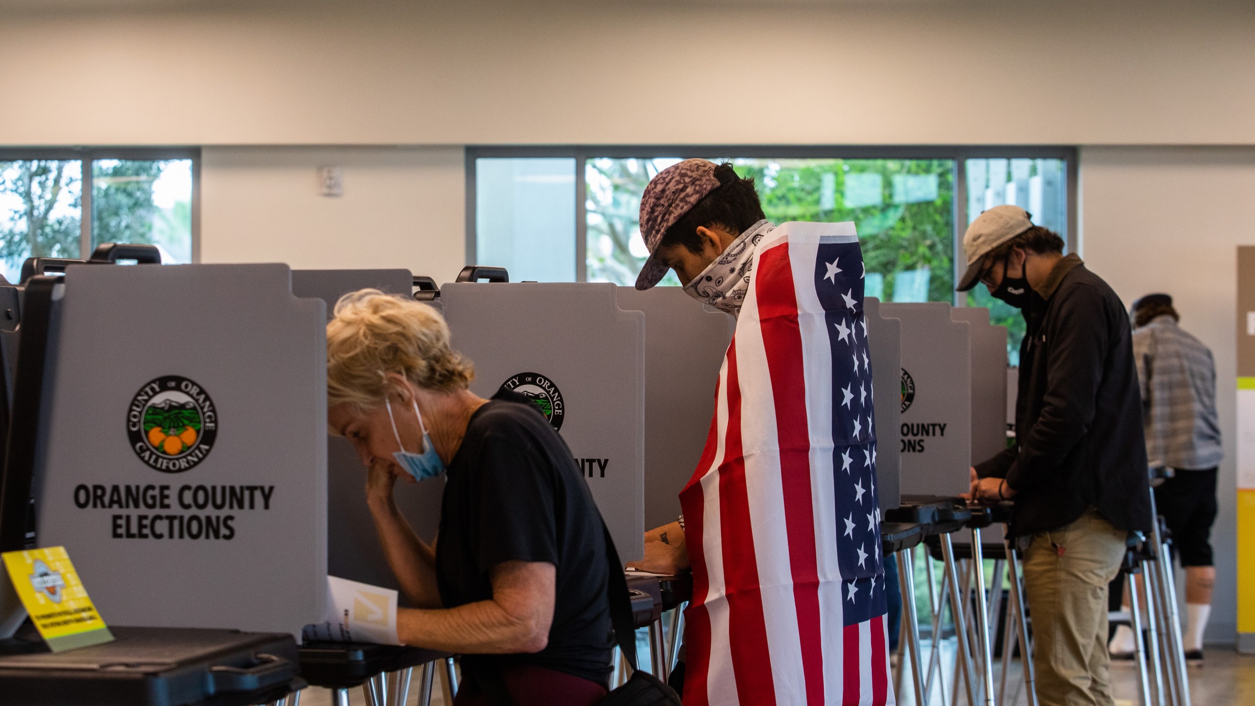 David Boston Angel, center, marks his ballot at Marina Park Community Vote Center on Nov. 3, 2020 in Newport Beach. (Apu Gomes/Getty Images)