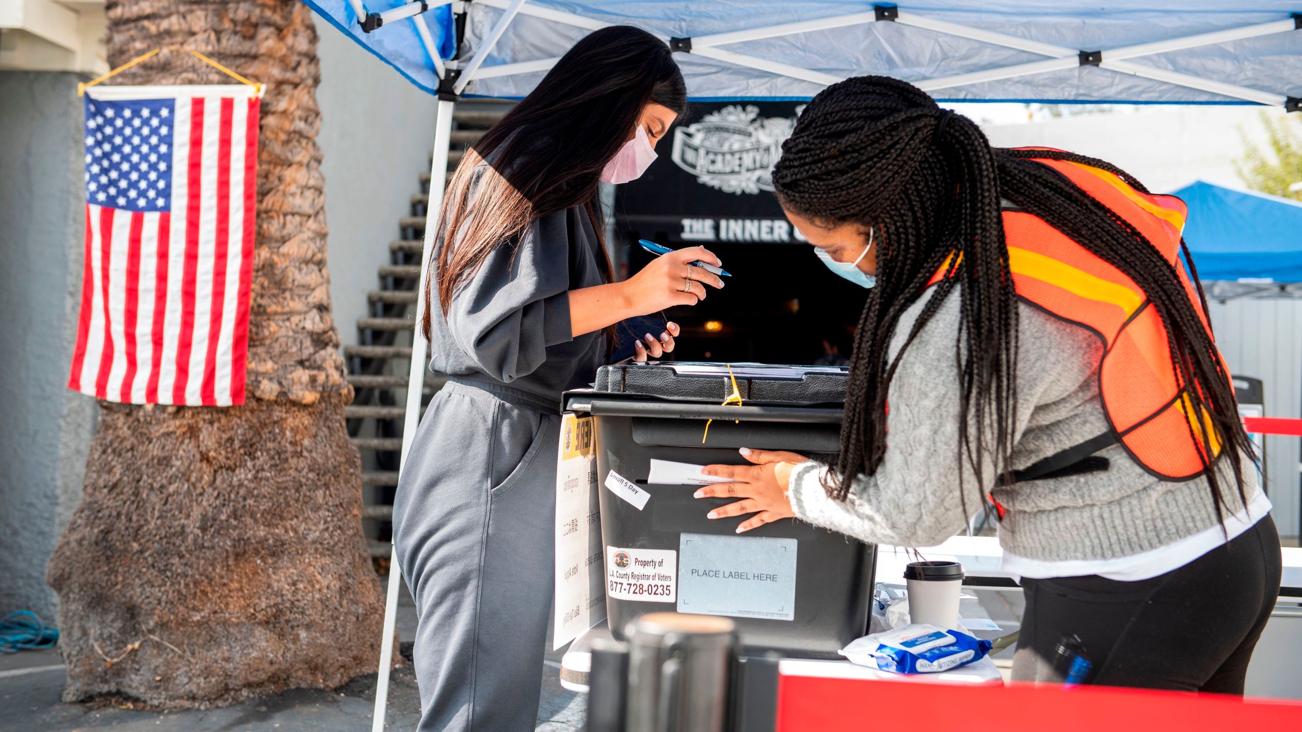 Volunteers work at the polling station at the Magic Castle in Hollywood on Nov. 3, 2020. (Valerie Macon / AFP / Getty Images)