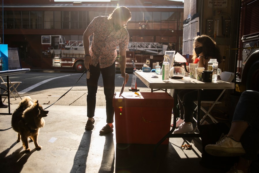 A voter casts a mail-in ballot at a polling station inside a San Francisco firehouse on Nov. 3, 2020. (Stephen Lam / Getty Images)