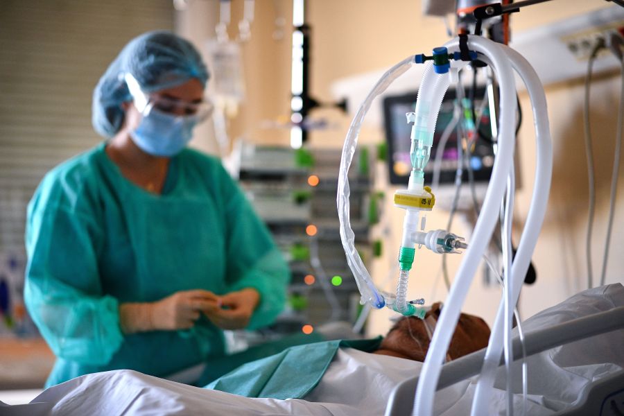 French intensive care nurse Gaelle Carpentier, 23, tends to a patient at an intensive care unit for patients infected with COVID-19 (novel coronavirus) at the Centre Hospitalier de l'Europe in Le Port-Marly, near Paris on Nov. 4, 2020. (ANNE-CHRISTINE POUJOULAT/AFP via Getty Images)