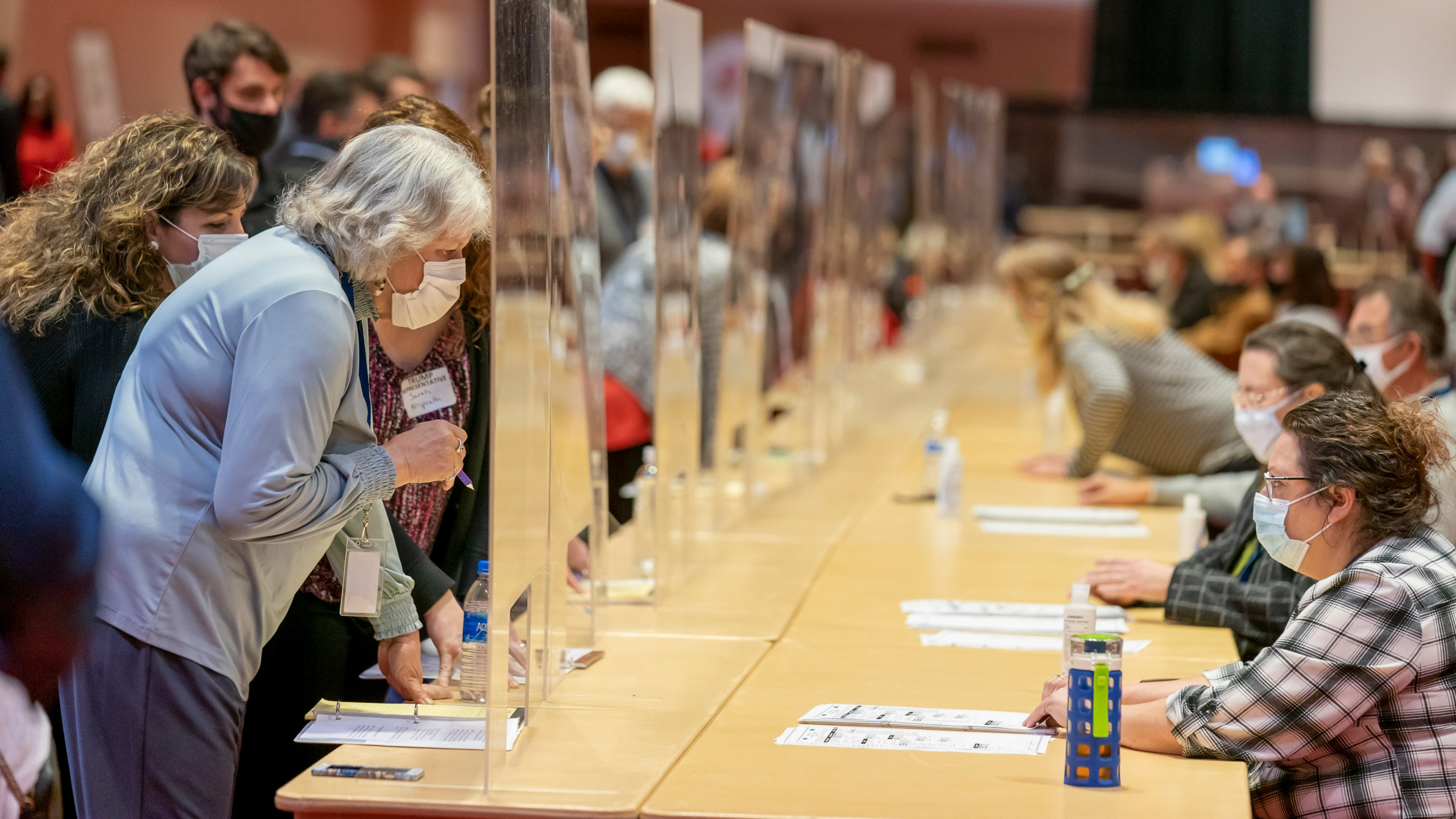 Representatives for President Donald Trump, left, look over a ballots during the presidential recount vote for Dane County on Nov. 20, 2020 in Madison, Wisc. President Donald Trump requested a recount of ballots in Milwaukee and Dane counties in Wisconsin, hoping to overturn his narrow defeat in the state to Democratic presidential nominee Joe Biden. Trump's campaign paid the state $3 million to cover the cost of the recount. (Andy Manis/Getty Images)