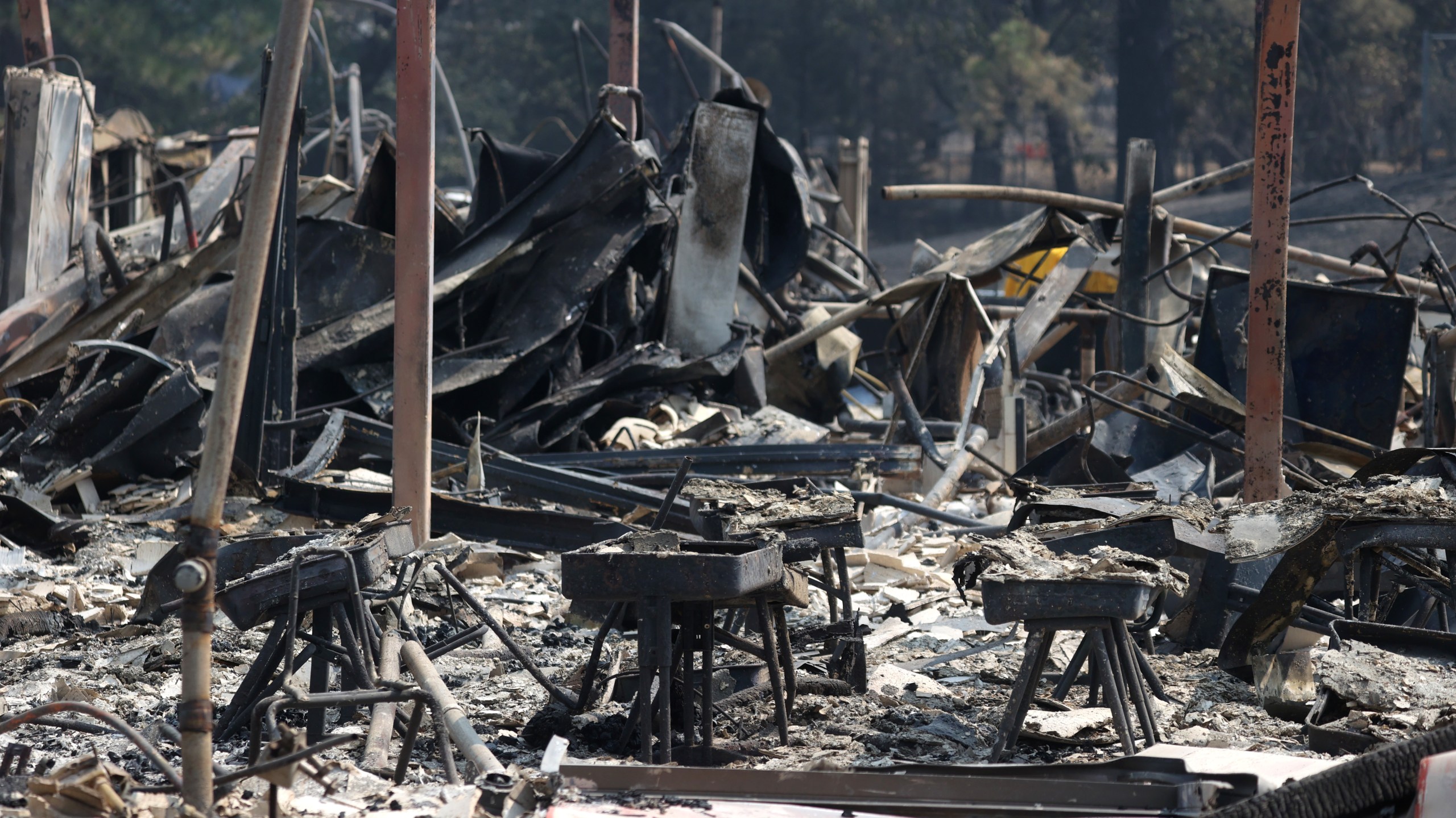 School desks sit in the rubble of the Berry Creek School after it was destroyed by the Bear Fire on Sept. 14, 2020 in Berry Creek, California. (Justin Sullivan/Getty Images)