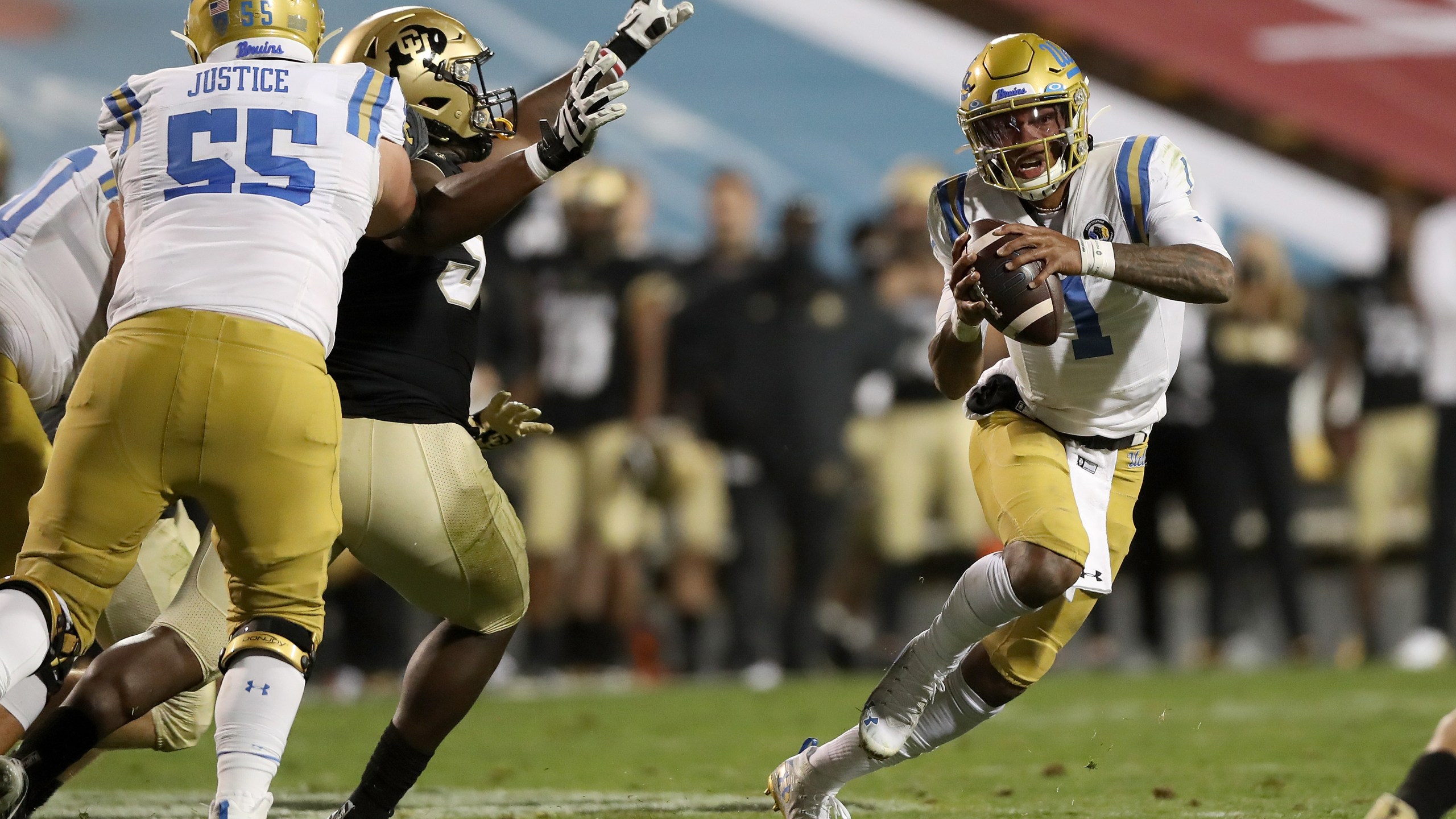 Quarterback Dorian Thompson-Robinson #1 of the UCLA Bruins runs out of the pocket against the Colorado Buffaloes in the fourth quarter at Folsom Field on November 07, 2020 in Boulder, Colorado. (Matthew Stockman/Getty Images)