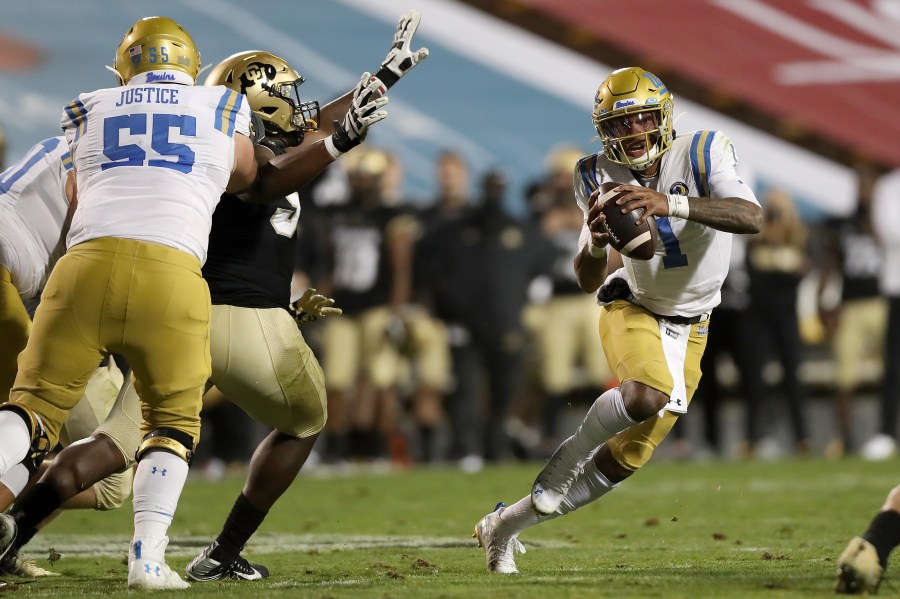 Quarterback Dorian Thompson-Robinson #1 of the UCLA Bruins runs out of the pocket against the Colorado Buffaloes in the fourth quarter at Folsom Field on November 07, 2020 in Boulder, Colorado. (Matthew Stockman/Getty Images)