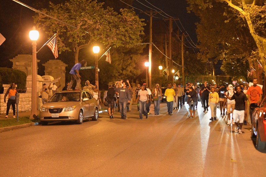 Demonstrators approach during a protest action through the Central West End of St. Louis, Missouri on August 20, 2015. (Michael B. Thomas/Getty Images)