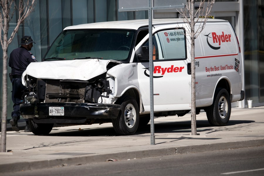 Police inspect a van suspected of being involved in a crash that injured multiple pedestrians on April 23, 2018 in Toronto, Canada. (Cole Burston/Getty Images)