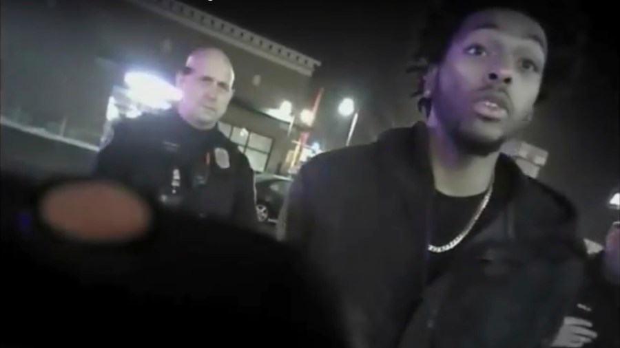 This file photo from Jan. 26, 2018, shows police body-camera footage released by Milwaukee Police Department that shows NBA Bucks guard Sterling Brown talking to arresting police officers after being shot by a stun gun in a Walgreens parking lot in Milwaukee. The Milwaukee city attorney is recommending a revised offer to settle a lawsuit brought by Milwaukee Bucks’ guard Sterling Brown, who was taken to the ground, shocked with a Taser and arrested during an encounter with police in 2018. City Attorney Tearman Spencer is recommending a $750,000 payment and an admission that Brown's constitutional rights were violated during the arrest. (Milwaukee Police Department via AP, File)