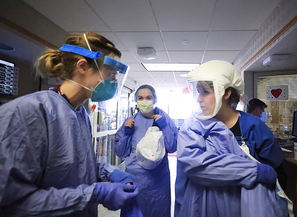 Medical staff attending to patients with COVID-19 wear protective equipment in a unit dedicated to treatment of the coronavirus at UW Health in Madison, Wis. (John Hart/Wisconsin State Journal via AP, File)