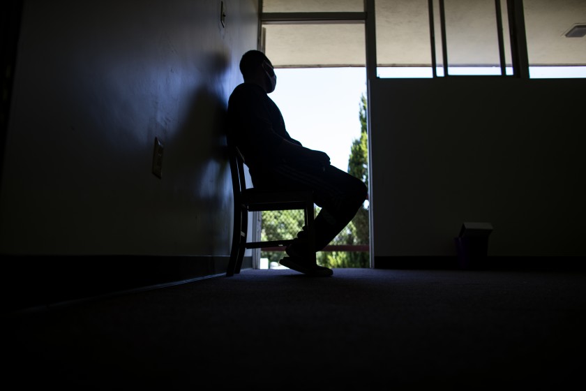 Tsegai sits in the doorway of his room while staying in a church on Sept. 22, 2020 in San Bernardino County. (Gina Ferazzi/Los Angeles Times)