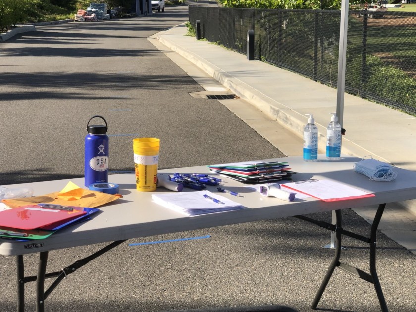 A table is set up at Sierra Canyon High to register and test players as they arrive for conditioning during the COVID-19 pandemic in 2020. (Eric Sondheimer / Los Angeles Times)