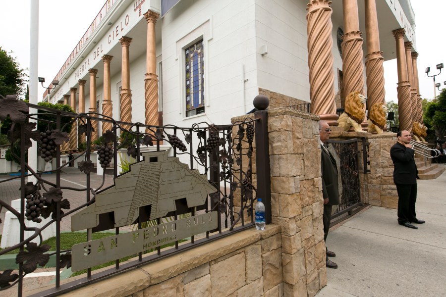 Members of the Mexico-based evangelical megachurch La Luz del Mundo stand outside the East Los Angeles temple on Friday, June 7, 2019. (AP Photo/Damian Dovarganes)