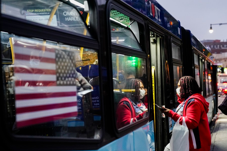 People wear protective masks during the coronavirus pandemic while boarding a bus near the Fordham Metro North station Thursday, Oct. 22, 2020, in New York. (Frank Franklin II/AP Photo)