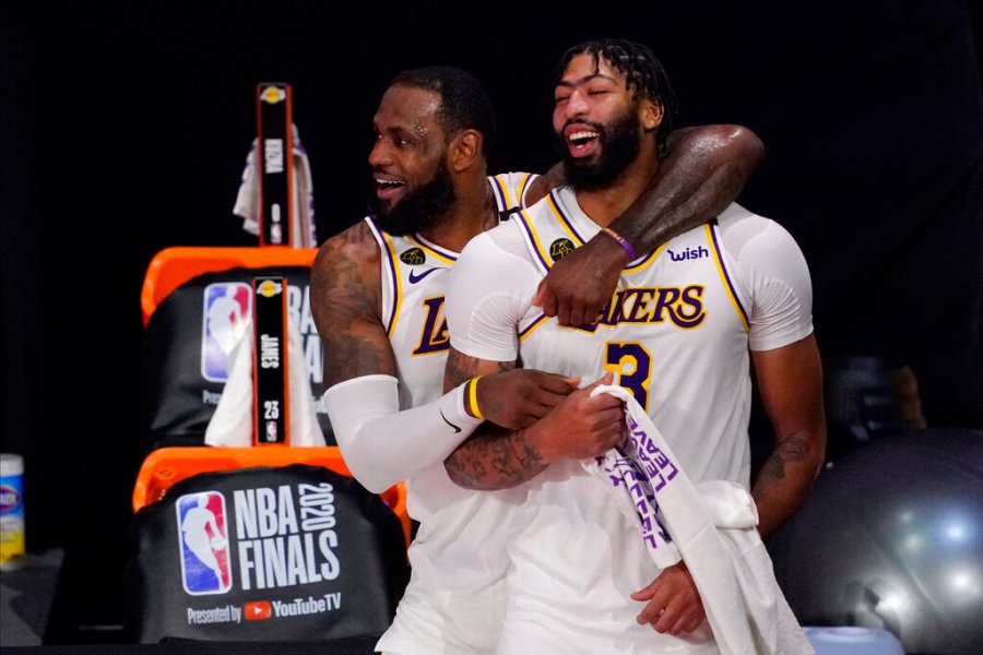 Los Angeles Lakers' LeBron James, rear, and Anthony Davis (3) celebrate after the Lakers defeated the Miami Heat 106-93 in Game 6 of basketball's NBA Finals in Lake Buena Vista, Fla., in this Oct. 11, 2020, file photo. (AP Photo/Mark J. Terrill, File)