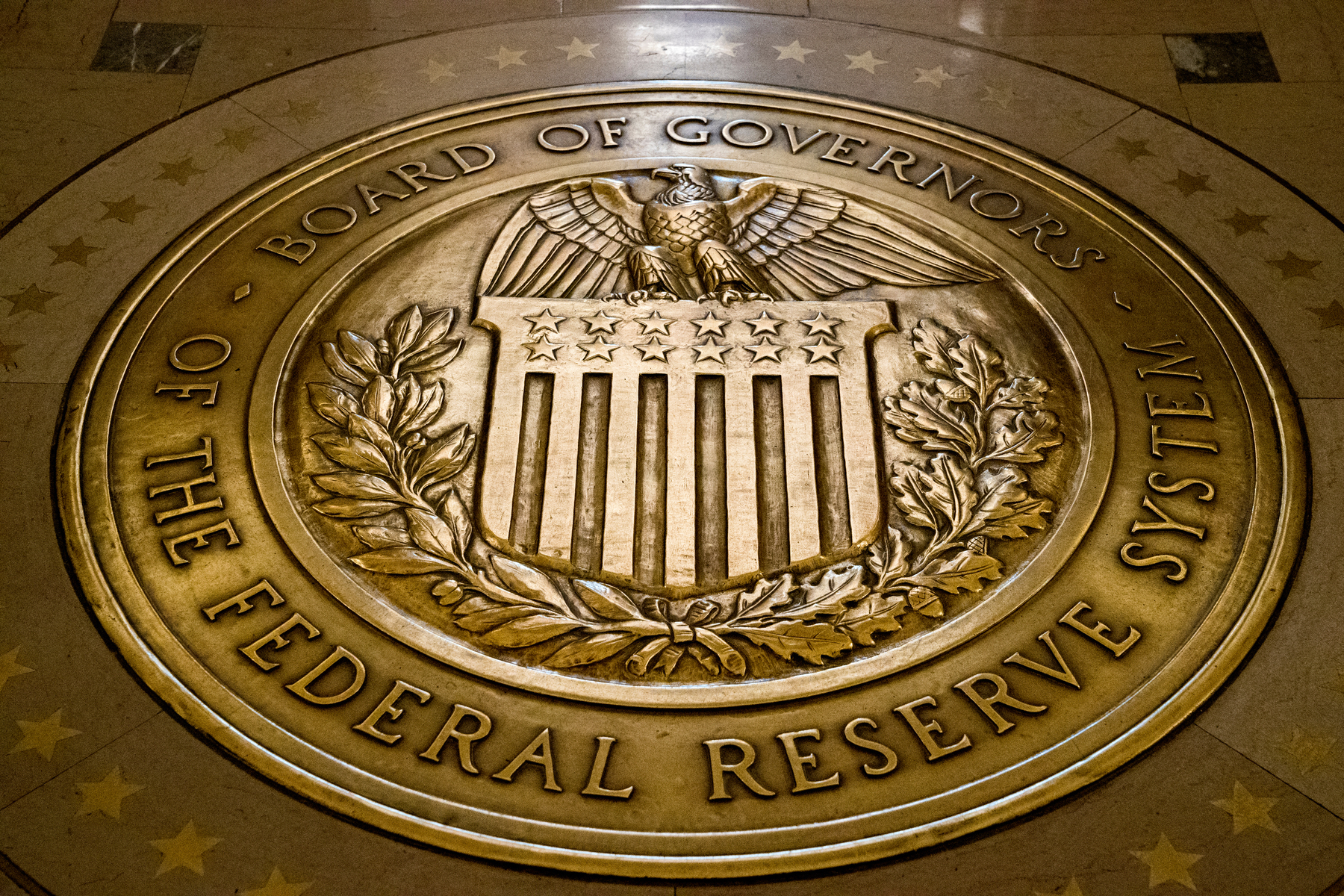 This Feb. 5, 2018, file photo shows the seal of the Board of Governors of the United States Federal Reserve System in the ground at the Marriner S. Eccles Federal Reserve Board Building in Washington. (Andrew Harnik/AP Photo)