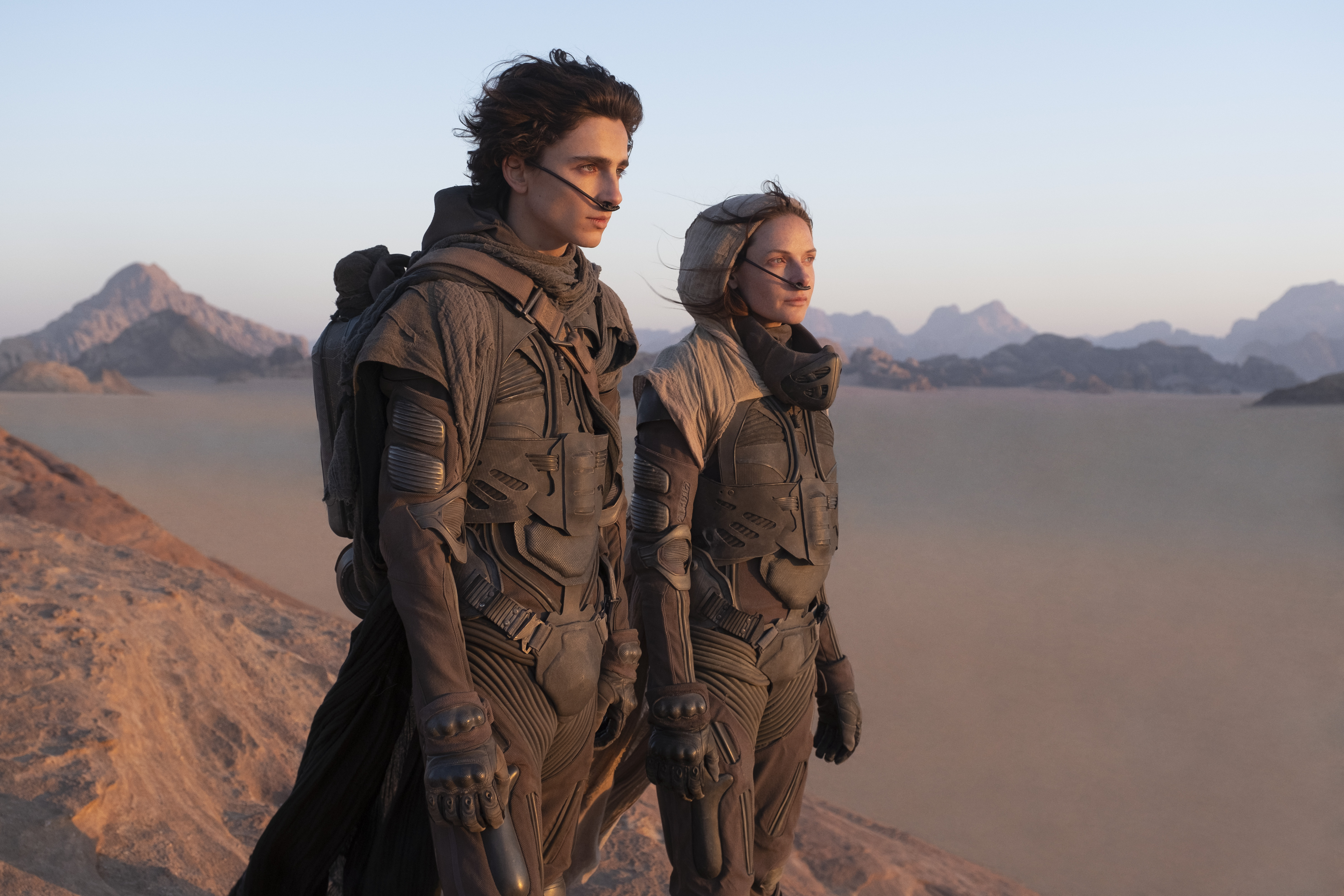 This image released by Warner Bros. Entertainment shows Timothee Chalamet, left, and Rebecca Ferguson in a scene from the upcoming 2021 film "Dune." Warner Bos. Pictures on Thursday announced that all of its 2021 film slate will stream on HBO Max at the same time they play in theaters. (Chia Bella James/Warner Bros. Entertainment via AP)