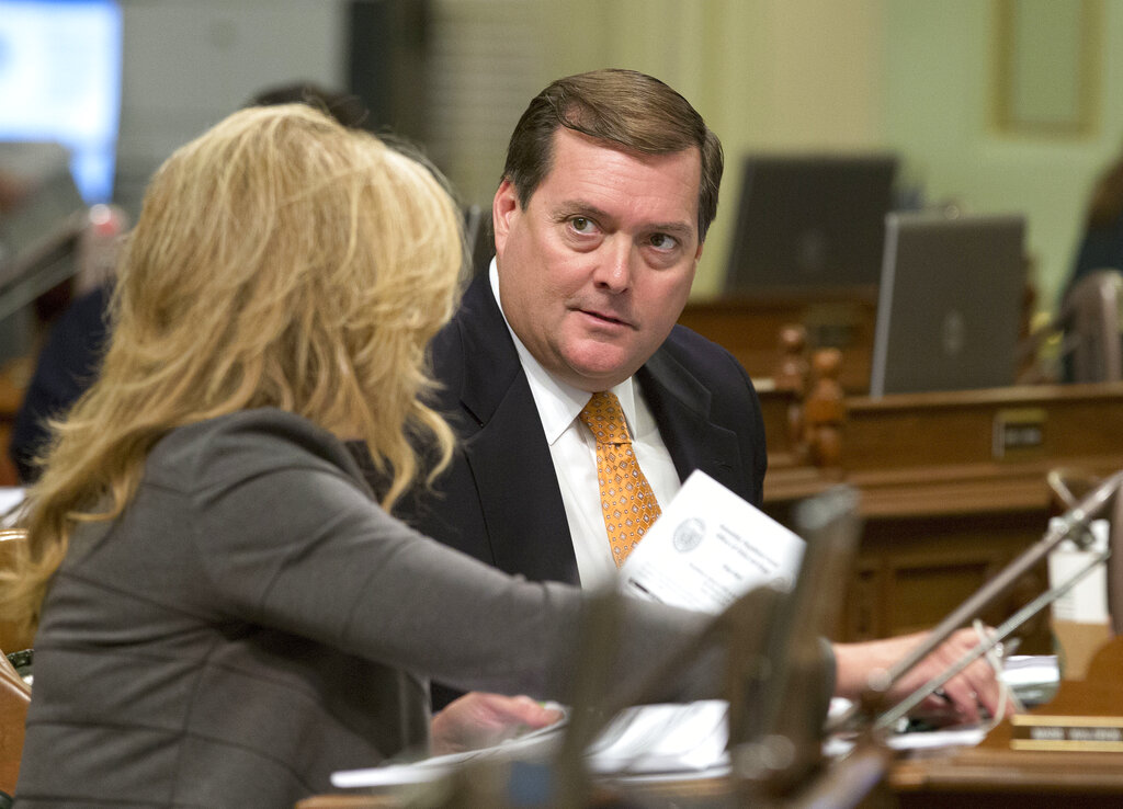 In this Aug. 30, 2016, file photo, Assemblyman Bill Brough, R-Dana Point, right, talks with Assemblywoman Marie Waldron, R-Escondido, in Sacramento, Calif. (AP Photo/Rich Pedroncelli, File)