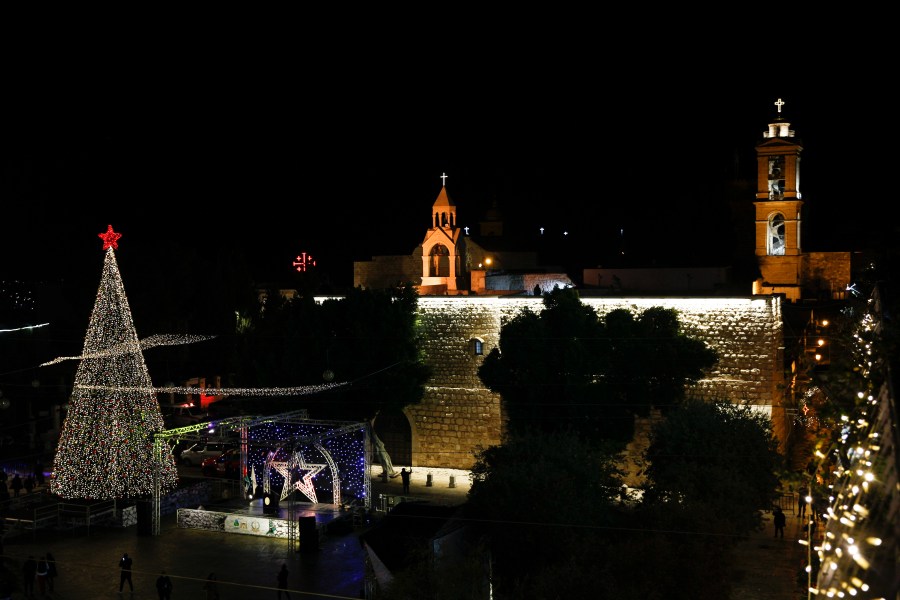 Christmas tree is lit outside the Church of the Nativity, traditionally believed by Christians to be the birthplace of Jesus Christ in the West Bank city of Bethlehem, Saturday, Dec. 5, 2020. (AP Photo/Majdi Mohammed)