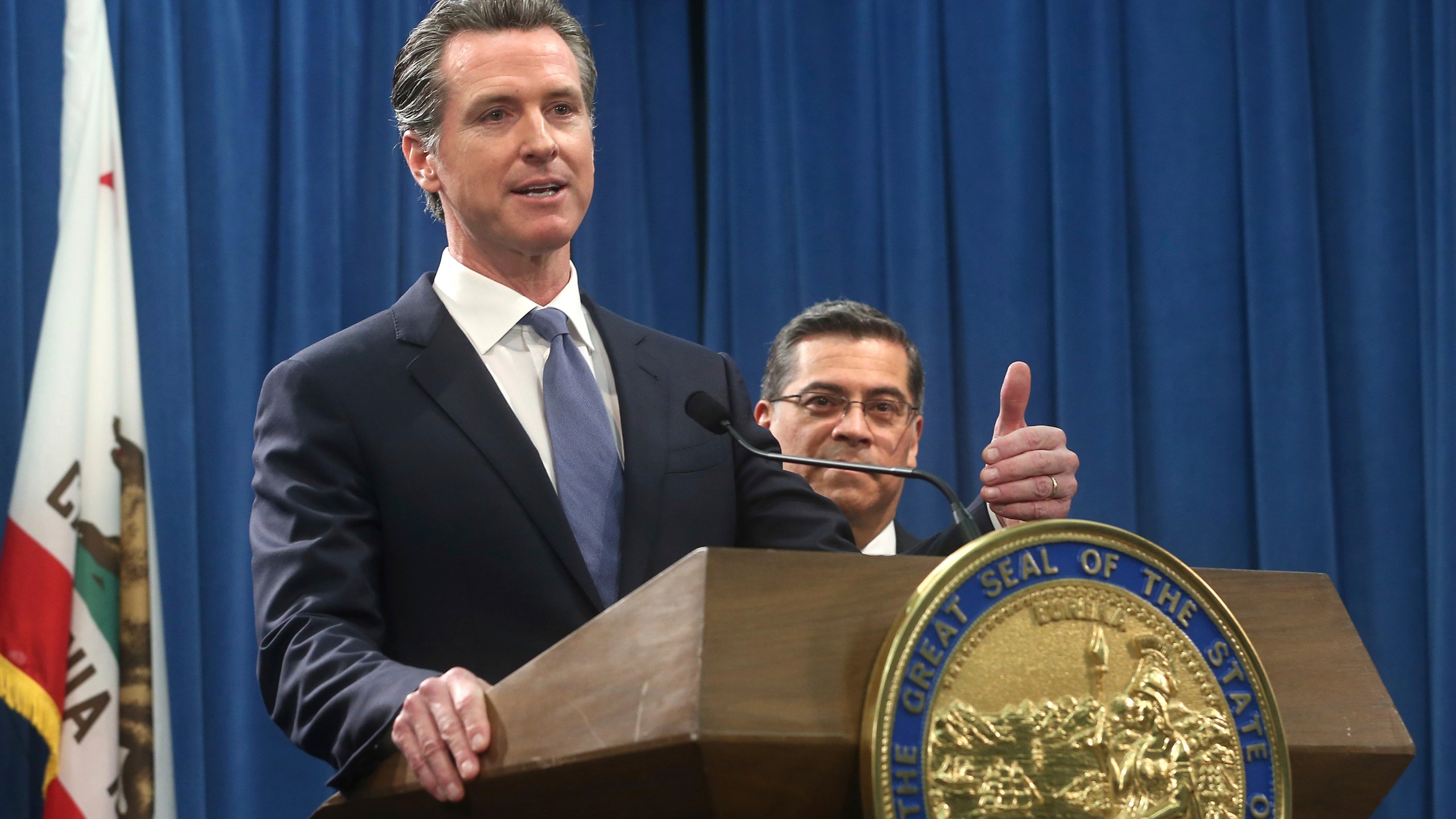 California Gov. Gavin Newsom, left, flanked by Attorney General Xavier Becerra, right, answers a question during a news conference in Sacramento on Feb. 15, 2019. (Rich Pedroncelli / Associated Press)