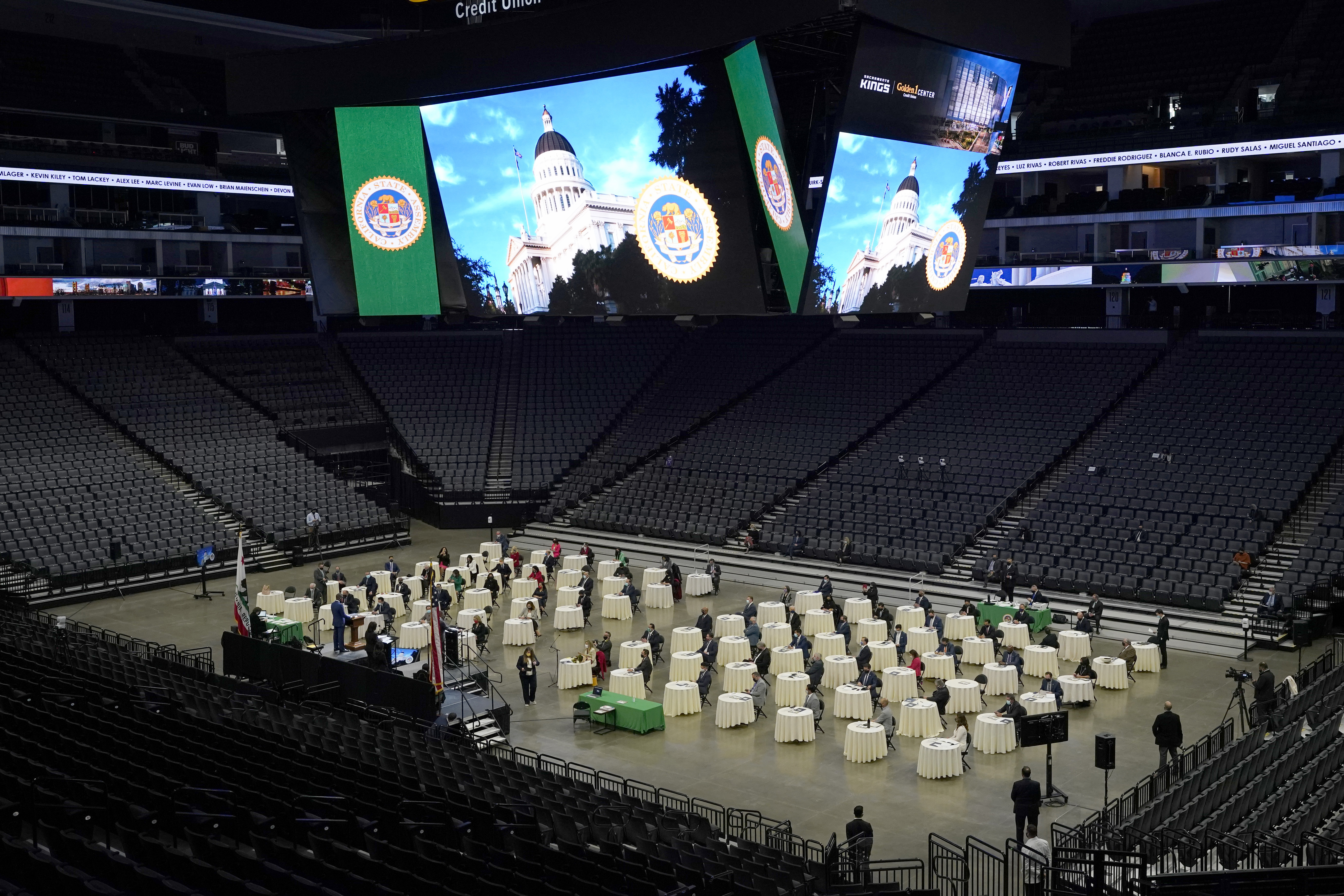 Members of the California State Assembly gathered on the floor of the Golden 1 Center for their organizational session in Sacramento, Calif., on Dec. 7, 2020. In order to follow social distancing guidelines, the Assembly session was held at the home of the Sacramento Kings. (AP Photo/Rich Pedroncelli)