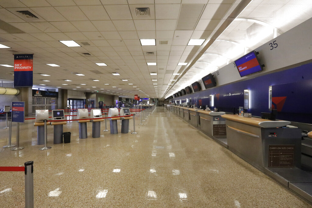 In this April 7, 2020, file photo, a Delta Air Lines ticket counter sits empty at Salt Lake City International Airport in Salt Lake City. (AP Photo/Rick Bowmer, File)