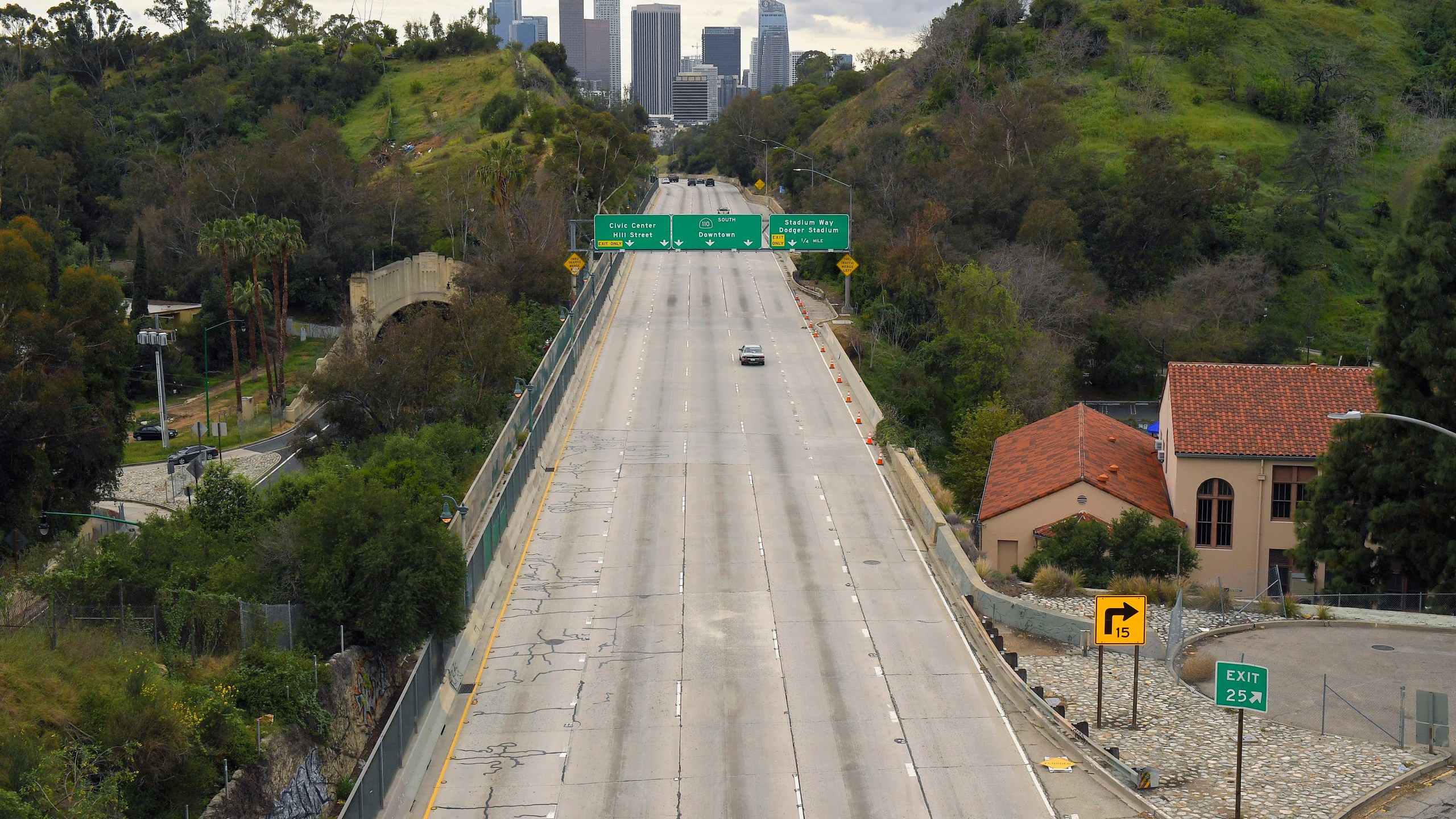 In this Friday, March 20, 2020 file photo, extremely light traffic moves along the 110 Harbor Freeway toward downtown Los Angeles in the mid-afternoon. Traffic would normally be bumper-to-bumper during this time of day on a Friday. New calculations released on Thursday, Dec. 10, 2020, show the world's carbon dioxide emissions plunged 7% in 2020 because of the pandemic lockdowns. (AP Photo/Mark J. Terrill)