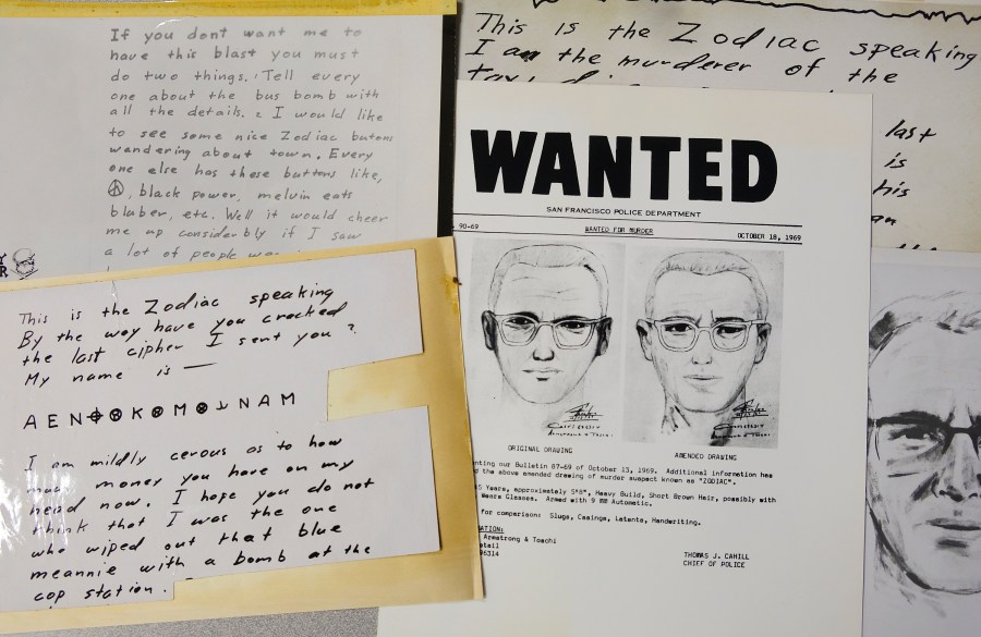 In this May 3, 2018, file photo, a San Francisco Police Department wanted bulletin and copies of letters sent to the San Francisco Chronicle by a man who called himself Zodiac are displayed in San Francisco. A coded letter mailed to a San Francisco newspaper by the Zodiac serial killer in 1969 has been deciphered by a team of amateur sleuths from the United States, Australia and Belgium, the San Francisco Chronicle reported Friday, Dec. 11, 2020. (AP Photo/Eric Risberg, File)