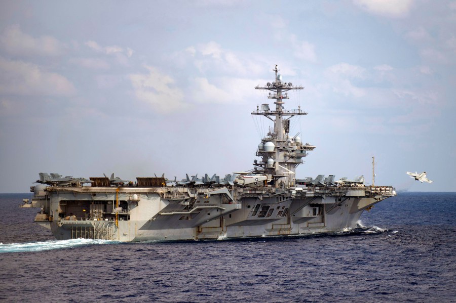 In this March 18, 2020 file photo provided by the U.S. Navy, an F/A-18F Super Hornet launches from the flight deck of the aircraft carrier USS Theodore Roosevelt (CVN 71) in the western North Pacific Ocean. (Mass Communication Specialist 3rd Class Nicholas V. Huynh/U.S. Navy via AP)