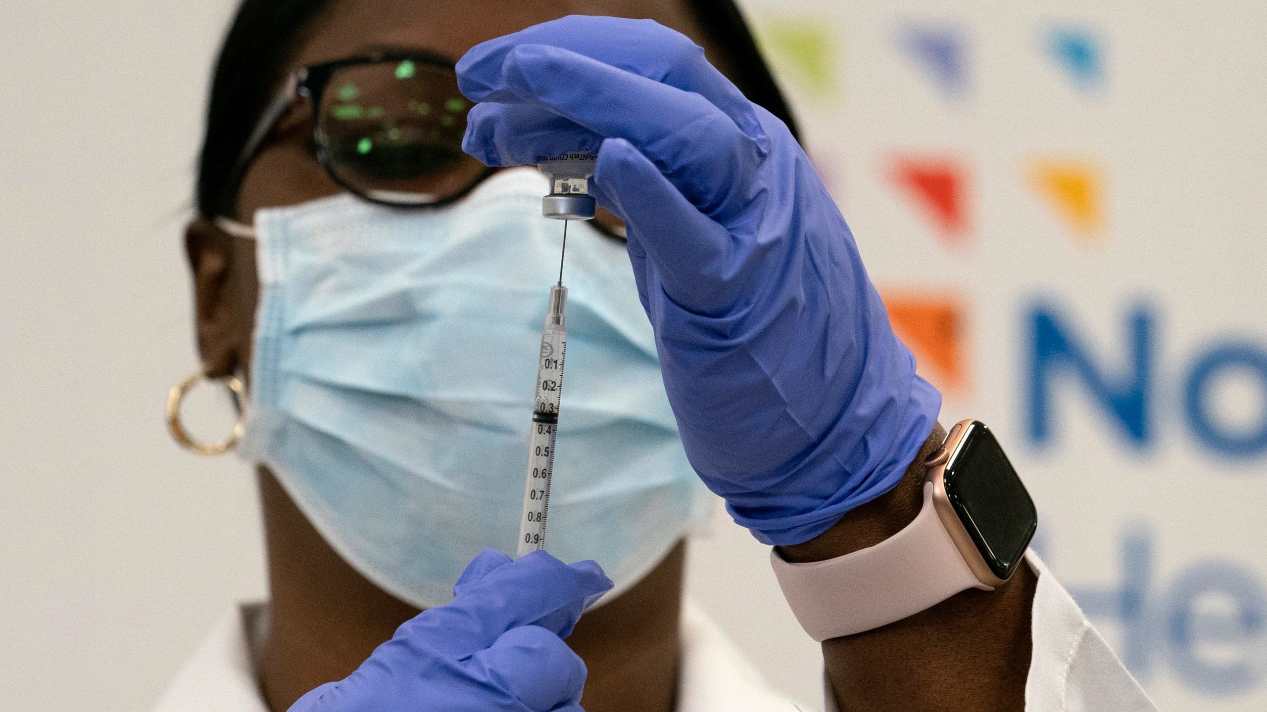 Dr. Michelle Chester draws the Pfizer-BioNTech COVID-19 vaccine into a syringe at Long Island Jewish Medical Center in the Queens borough of New York on Dec. 14, 2020. (Mark Lennihan / Associated Press)