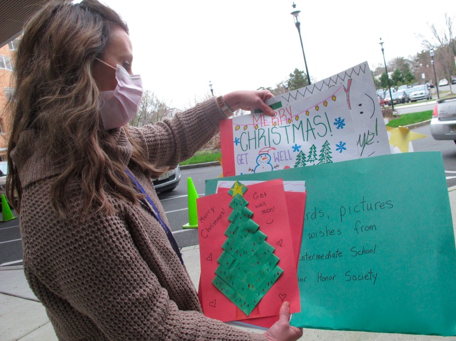 Kathleen Schallus sort through holiday cards sent to Shore Medical Center in Somers Point, N.J. on Dec. 8, 2020. (Wayne Parry/AP Photo)