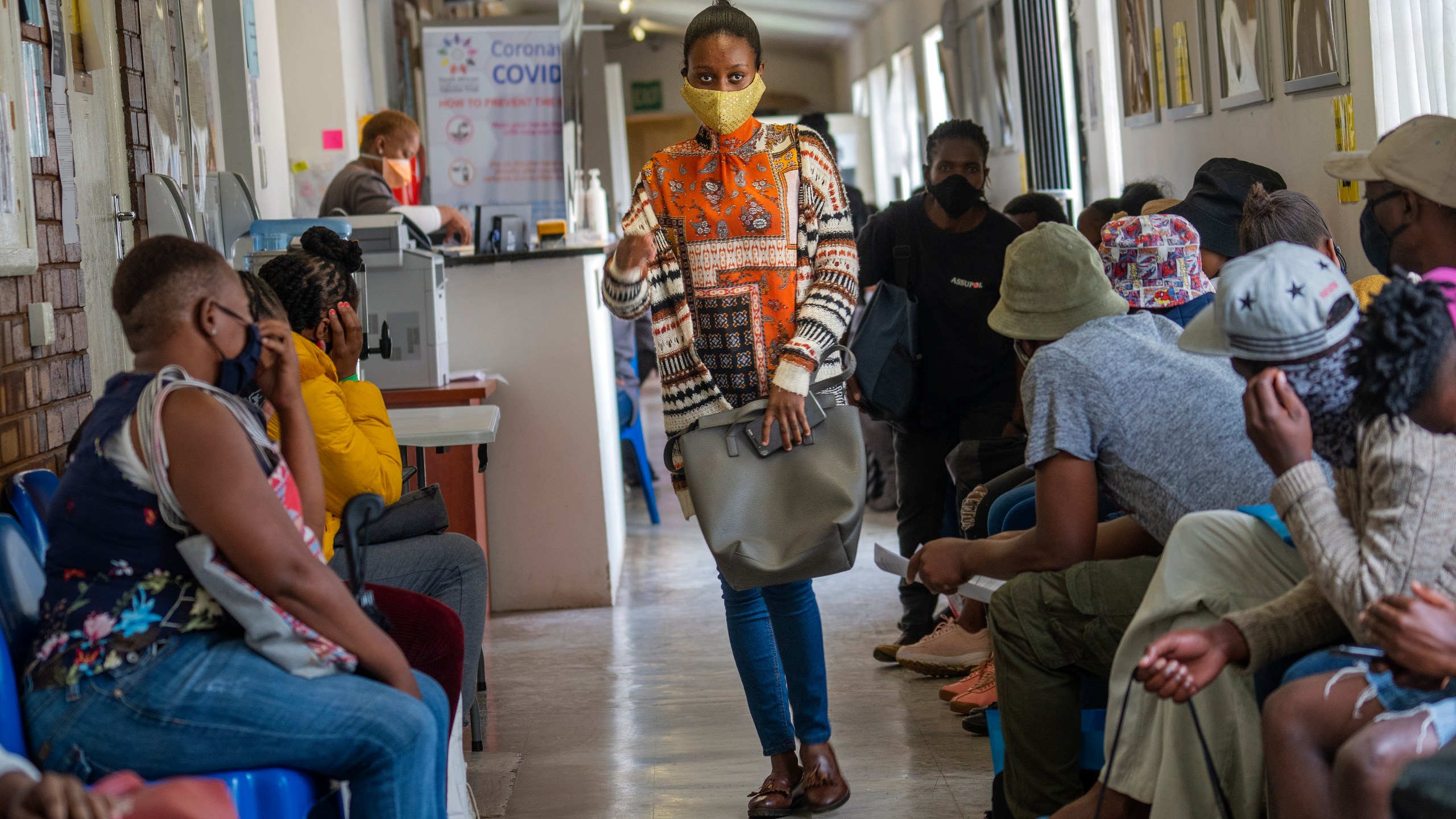 Volunteers wait to be checked at a vaccine trial facility for AstraZeneca at Soweto's Chris Sani Baragwanath Hospital outside Johannesburg, South Africa on Nov. 30, 2020. (AP Photo/Jerome Delay)