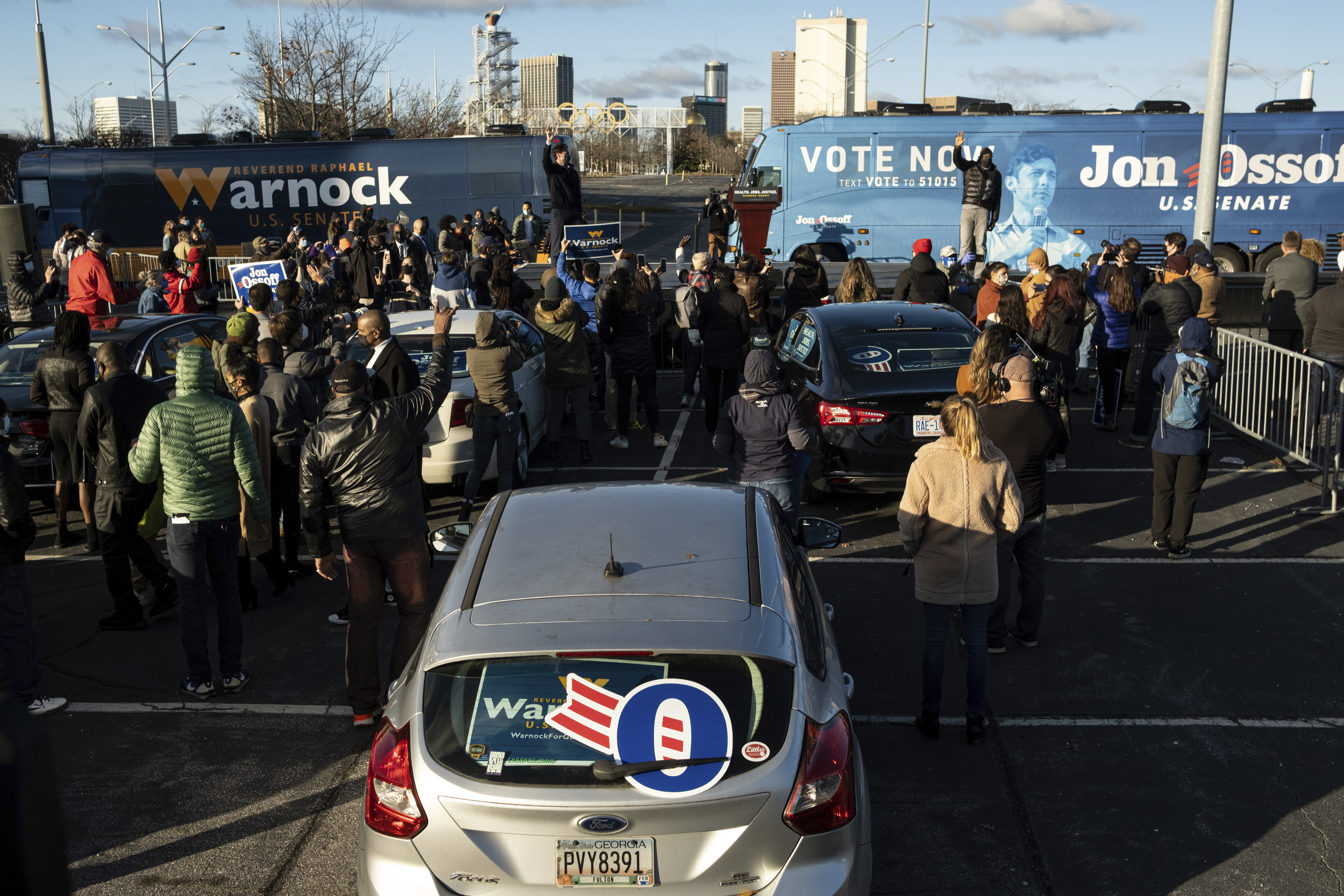 Democratic Georgia Senate challengers Rev. Raphael Warnock and Jon Ossoff hold a rally in Atlanta on the first day of early voting for the senate runoff Monday, Dec. 14, 2020. (AP Photo/Ben Gray)