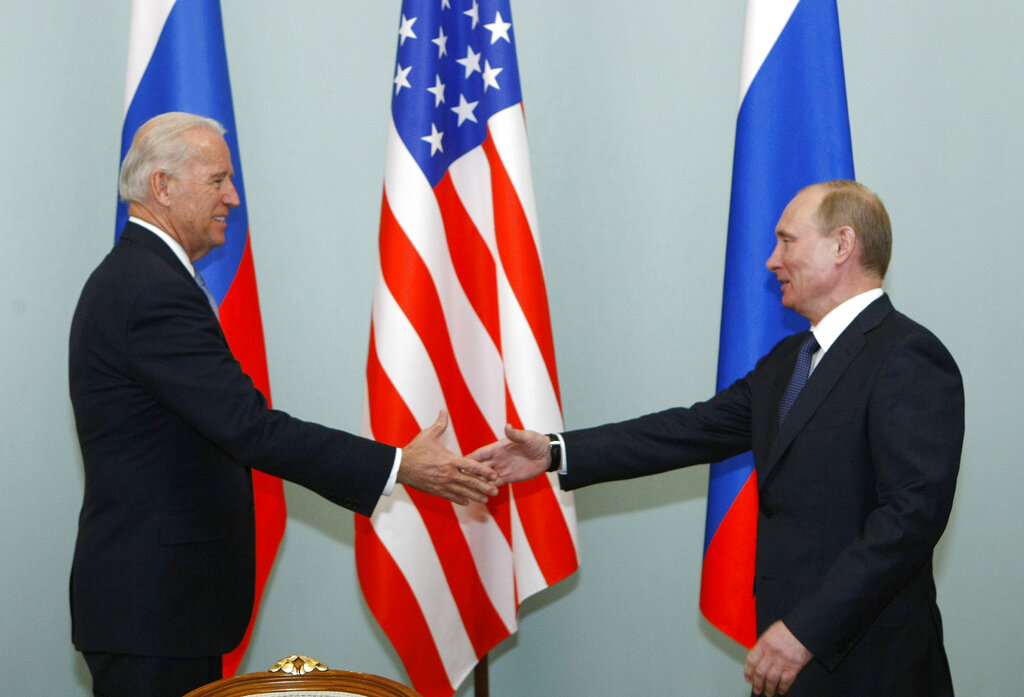 In this March 10, 2011, file photo, Vice President of the United States Joe Biden, left, shakes hands with Russian Prime Minister Vladimir Putin in Moscow, Russia. (AP Photo/Alexander Zemlianichenko, File)