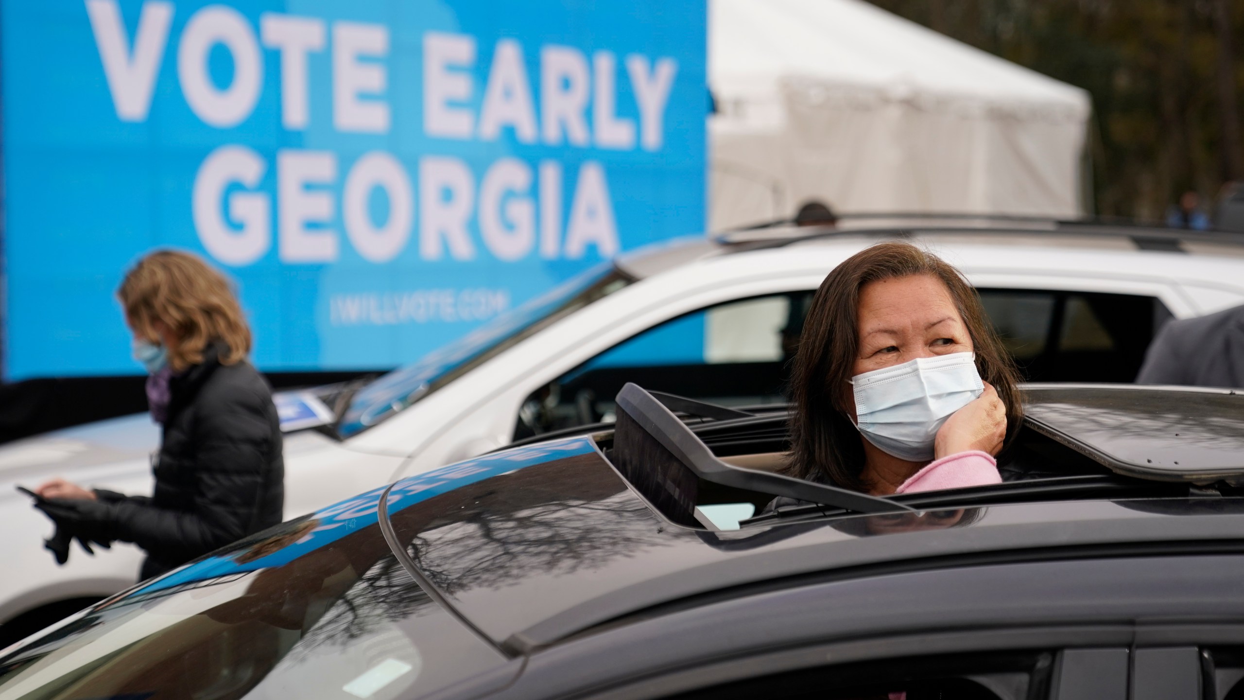 Attendees wait for President-elect Joe Biden to be introduced at a drive-in rally for Georgia Democratic candidates for U.S. Senate Raphael Warnock and Jon Ossoff on Dec. 15, 2020, in Atlanta. (AP Photo/Patrick Semansky)