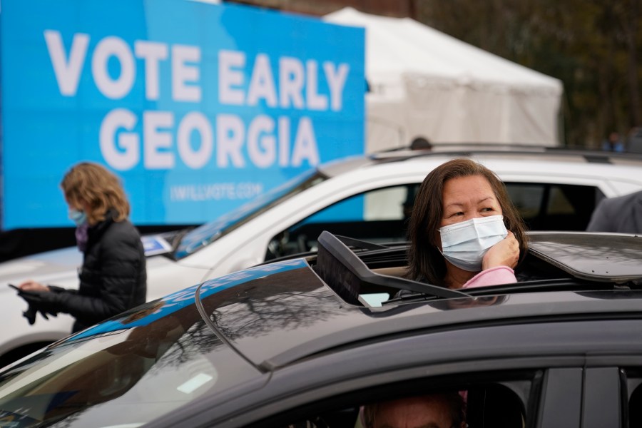 Attendees wait for President-elect Joe Biden to be introduced at a drive-in rally for Georgia Democratic candidates for U.S. Senate Raphael Warnock and Jon Ossoff on Dec. 15, 2020, in Atlanta. (AP Photo/Patrick Semansky)