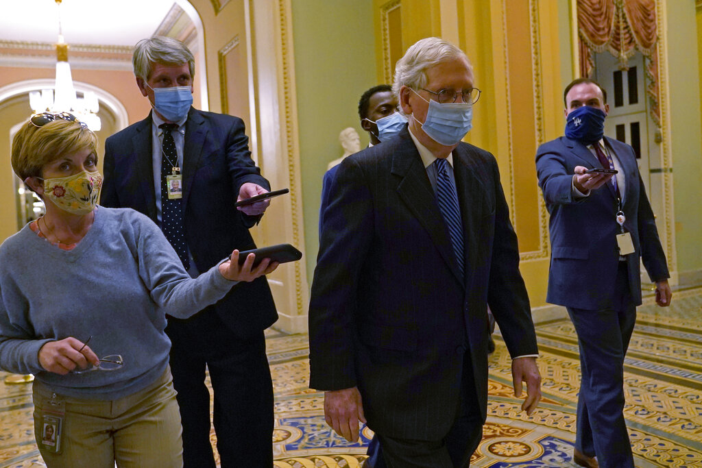 Senate Majority Leader Mitch McConnell of Ky., walks past reporters on Capitol Hill in Washington, Tuesday, Dec. 15, 2020. (AP Photo/Susan Walsh)