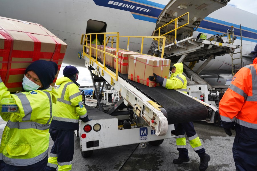 Wearing protective masks, ground crew at the Los Angeles International airport unload supplies of medical personal protective equipment from a China Southern cargo plane upon it's arrival on Friday, April 10, 2020. (Richard Vogel/AP Photo)