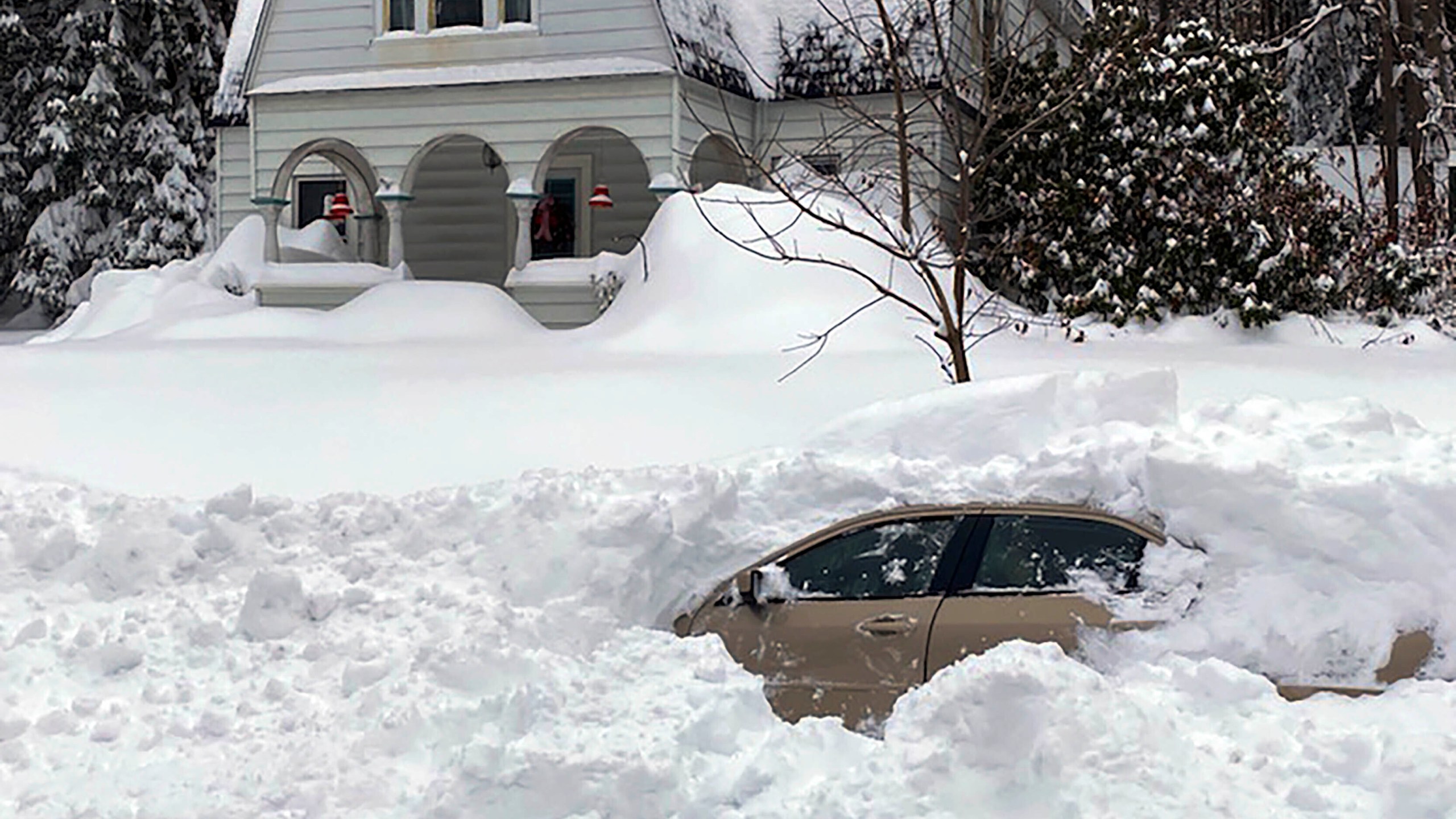 This photo, provided by the New York State Police, shows a car, in Oswego, NY, from which a New York State Police sergeant rescued Kevin Kresen, 58, of Candor, NY, stranded for 10 hours, covered by nearly 4 feet of snow thrown by a plow during this week's storm. (New York State Police via AP)