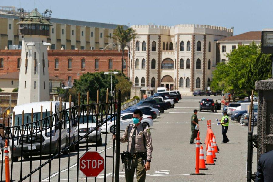 In this July 9, 2020, file photo, a correctional officer closes the main gate at San Quentin State Prison in San Quentin. (AP Photo/Eric Risberg, File)