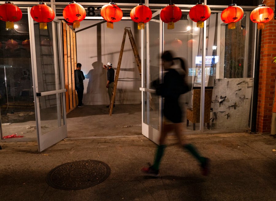 A runner jogs past a former Chinese restaurant being converted into an artist space in the Chinatown district of Los Angeles, Thursday, Dec. 17, 2020. (AP Photo/Damian Dovarganes)