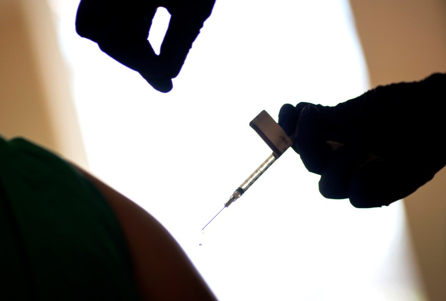 In this Tuesday, Dec. 15, 2020 file photo, a droplet falls from a syringe after a health care worker is injected with the Pfizer-BioNTech COVID-19 vaccine at Women & Infants Hospital in Providence, R.I. (AP Photo/David Goldman, File)