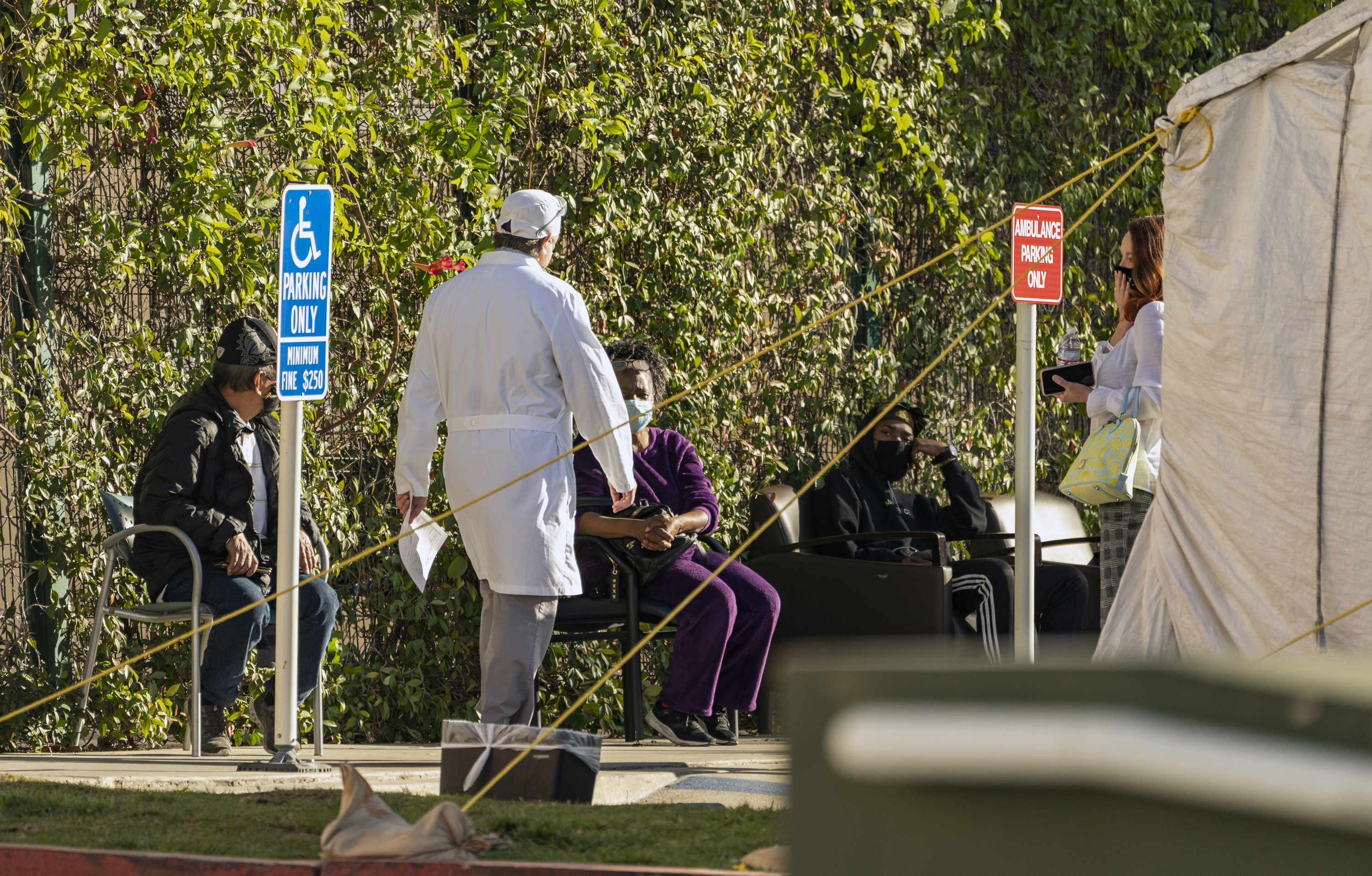 Patients wait in line for medical evaluation next to medical tents set at the CHA Hollywood Presbyterian Medical Center in Los Angeles Friday, Dec. 18, 2020. (Damian Dovarganes/AP Photo)