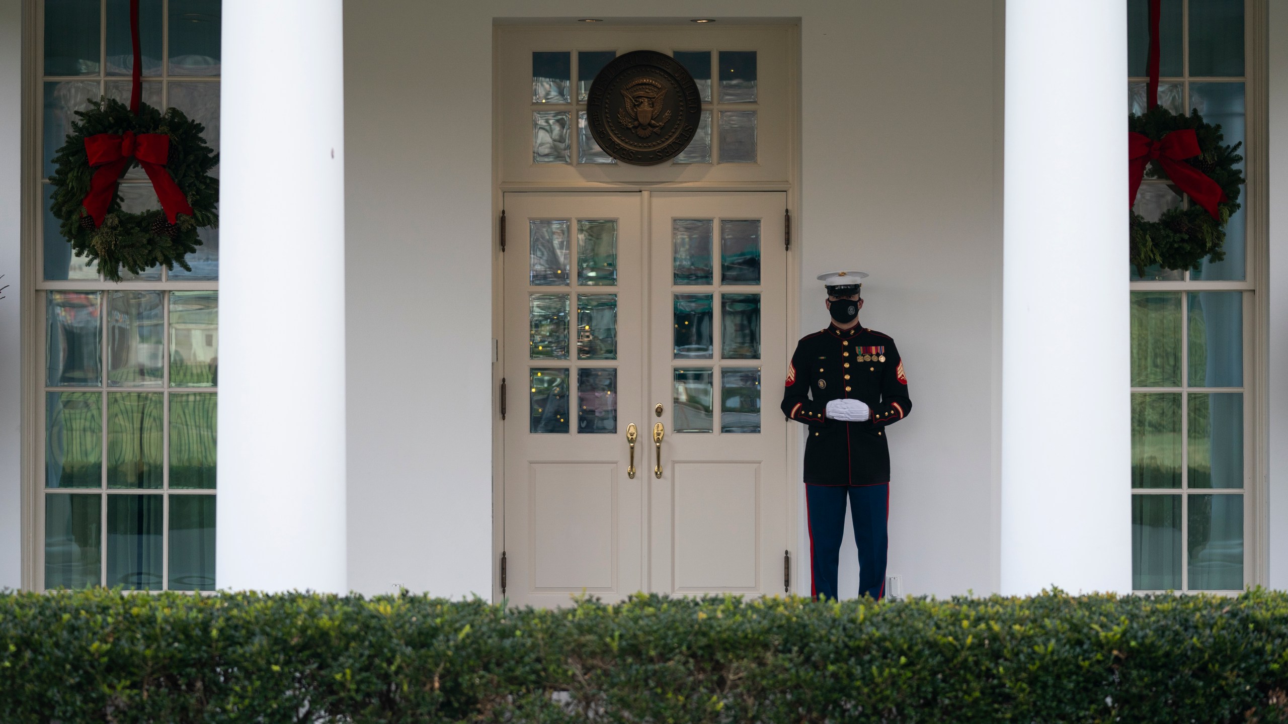 A Marine stands outside the entrance to the West Wing of the White House, signifying the President is in the Oval Office, Monday, Dec. 21, 2020, in Washington. (Evan Vucci/AP Photo)