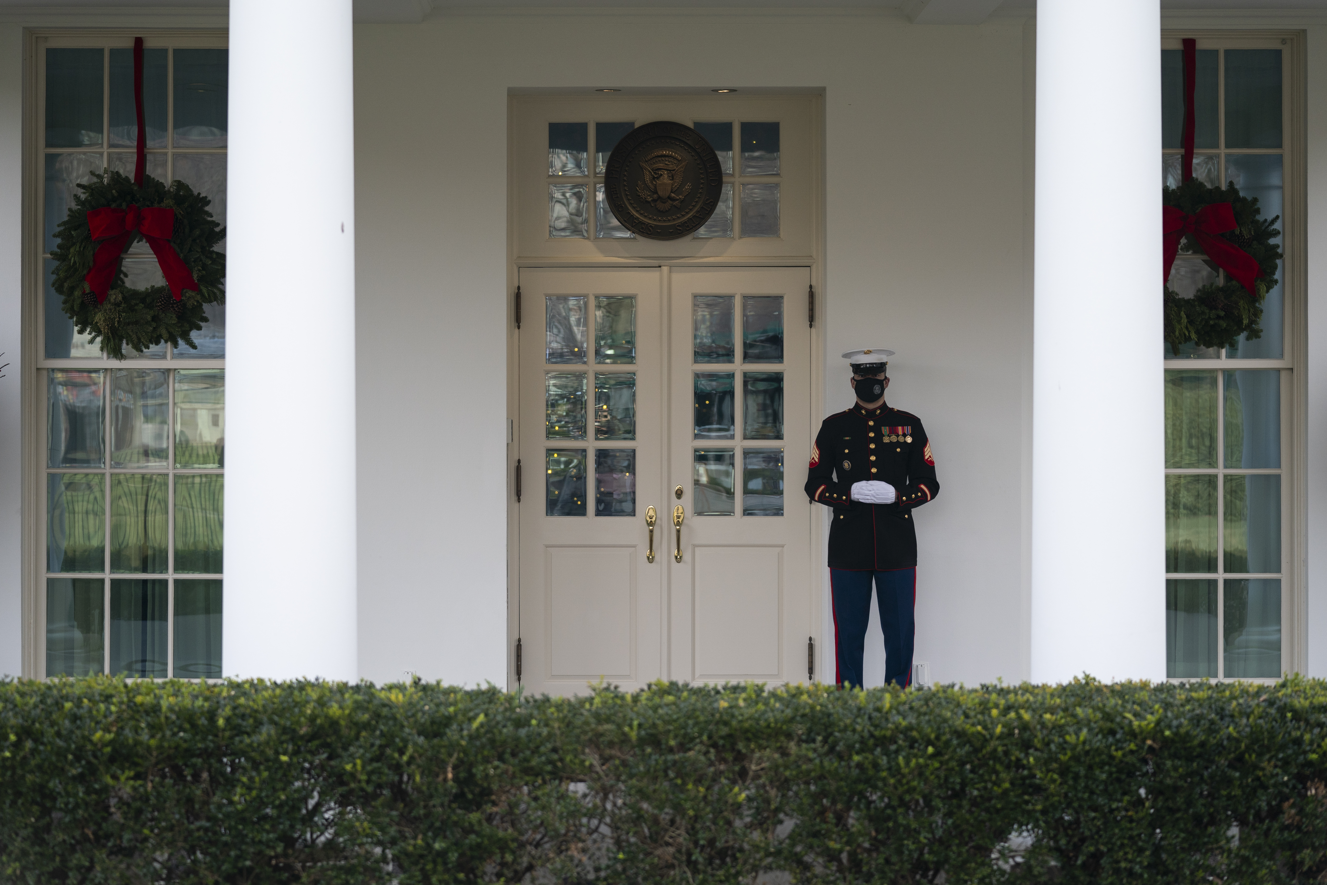 A Marine stands outside the entrance to the West Wing of the White House, signifying the President is in the Oval Office, Monday, Dec. 21, 2020, in Washington. (Evan Vucci/AP Photo)