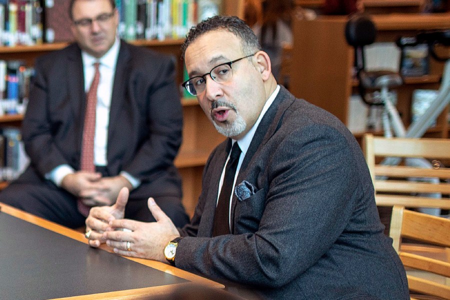 In this Jan. 28, 2020 file photo, Connecticut State Commissioner of Education Miguel Cardona speaks with Berlin High School students while on a tour of the school. (Devin Leith-Yessian/Berlin Citizen/Record-Journal via AP)