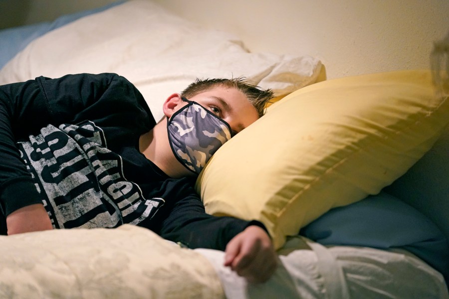 Cooper Wuthrich rests as he lays on a bed at the truck stop his family partly owns Tuesday, Dec. 15, 2020, in Montpelier, Idaho. (Rick Bowmer/AP Photo)